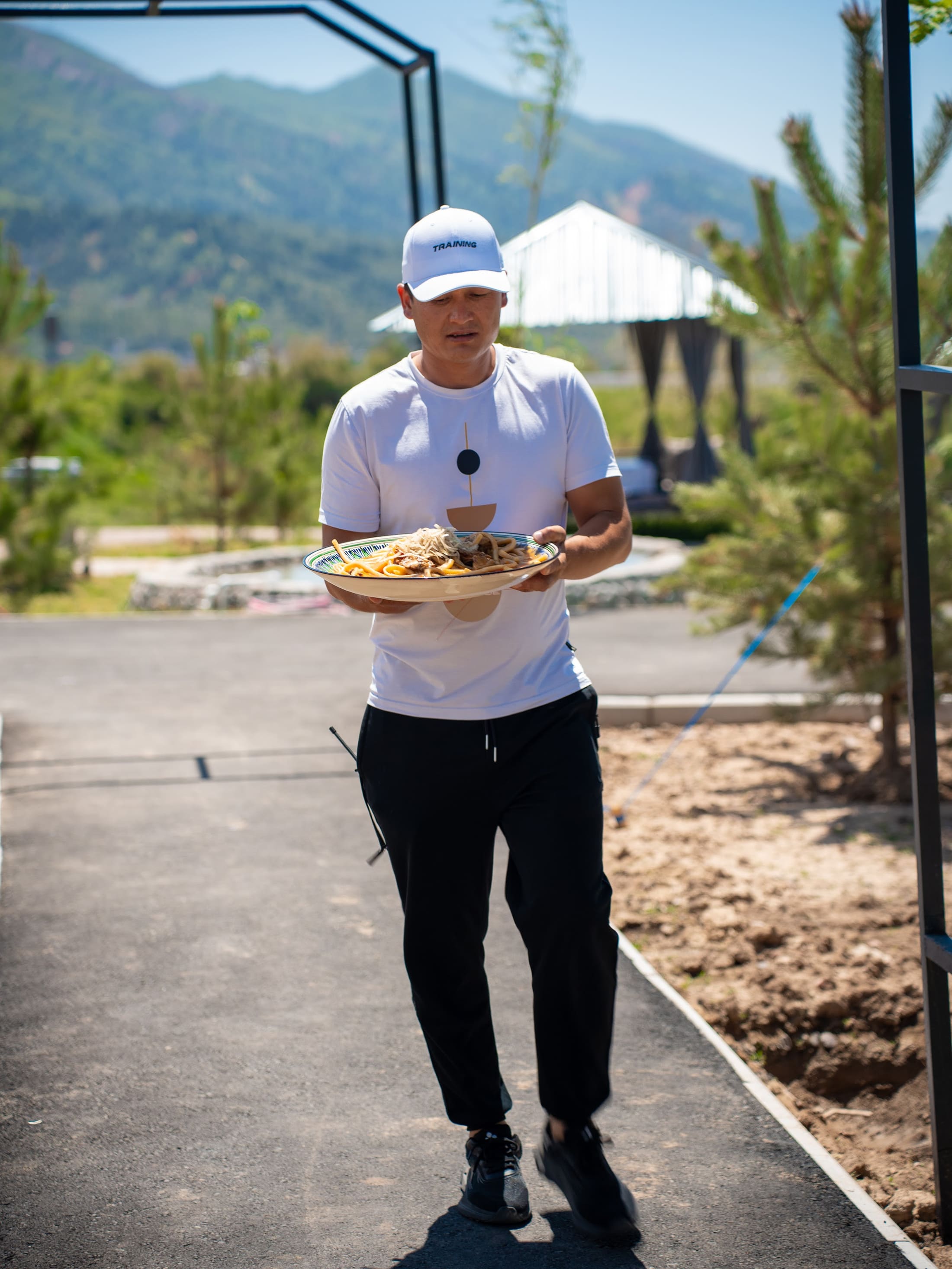 Waiter carrying dishes to guests